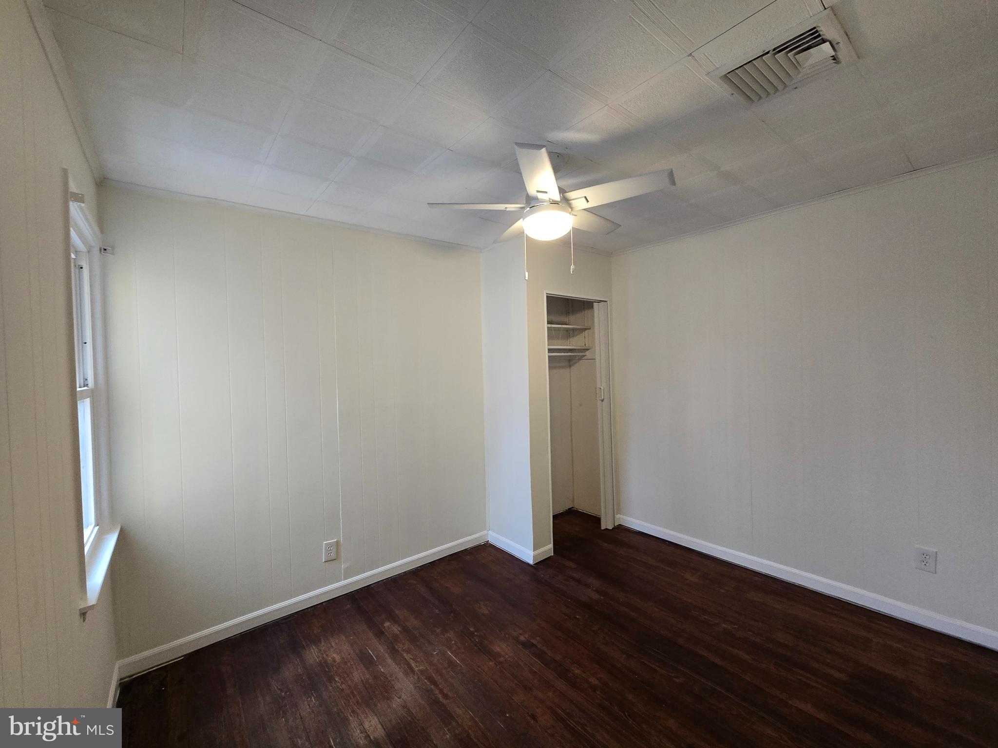 130 South Broadway Pitman, NJ 08071 - Photo 8 of 11 an empty room with wooden floor and ceiling fan