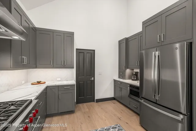 a kitchen with a refrigerator sink and stove