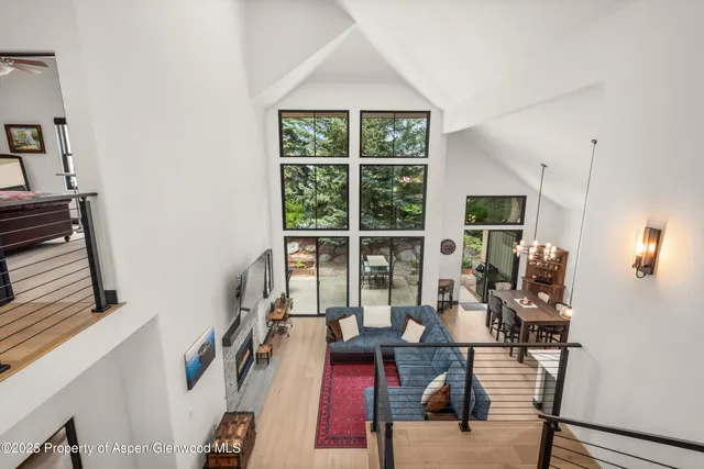 a living room with furniture and large windows