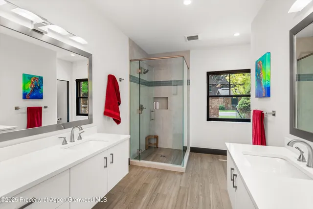 a bathroom with a tub sink and mirror