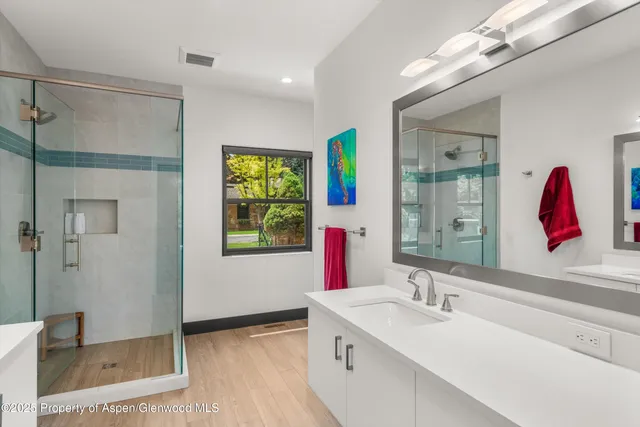 a bathroom with a tub sink and mirror