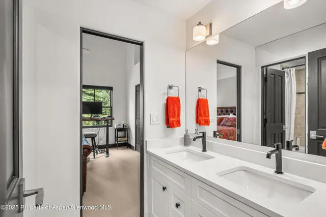 a bathroom with a sink double vanity and mirror