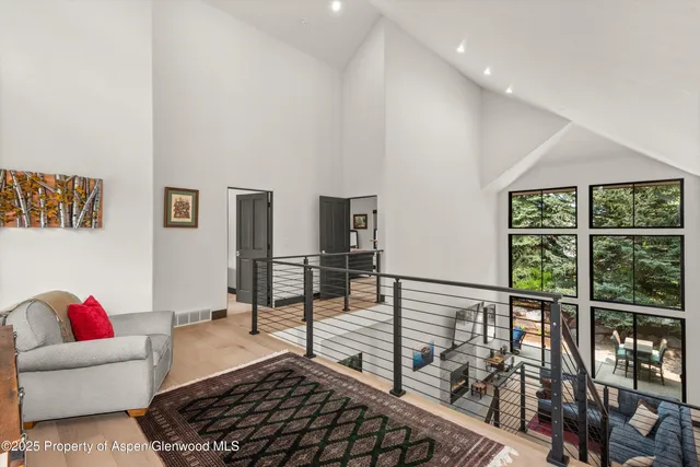 a living room with furniture and a floor to ceiling window