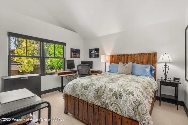 a bed room with a bed and a window