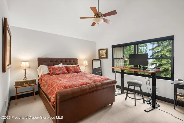 a bedroom with a bed and a desk