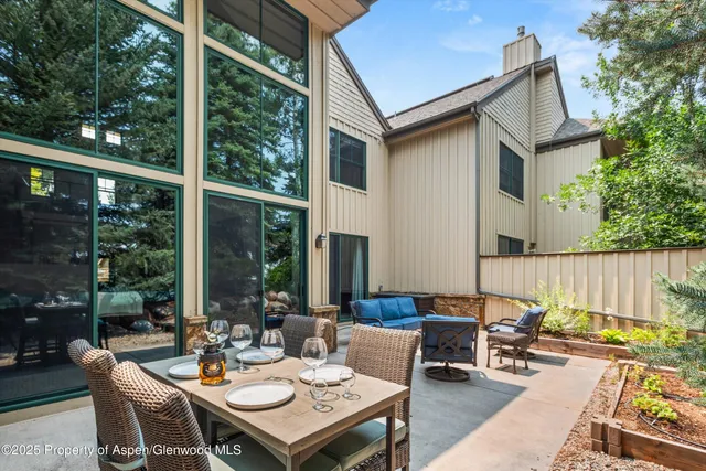 a view of a patio with a dining table and chairs