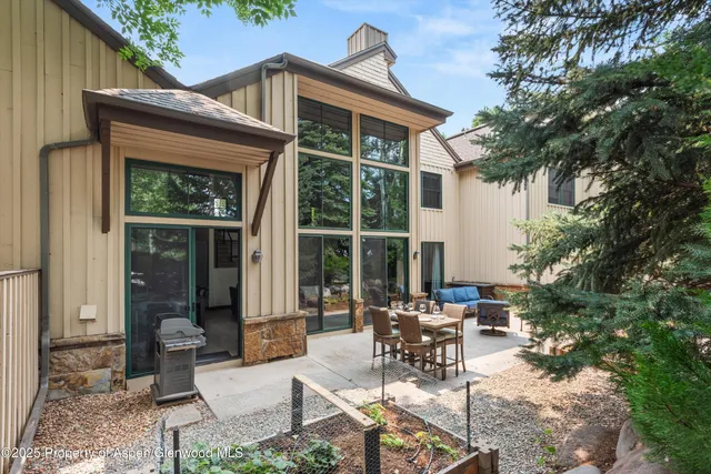a view of a patio with table and chairs and potted plants