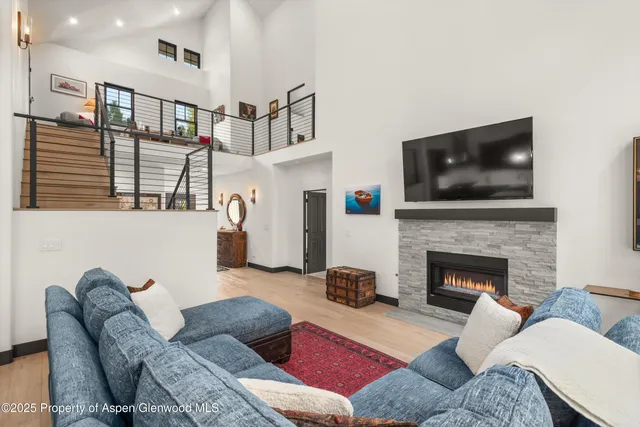a living room with furniture fireplace and flat screen tv