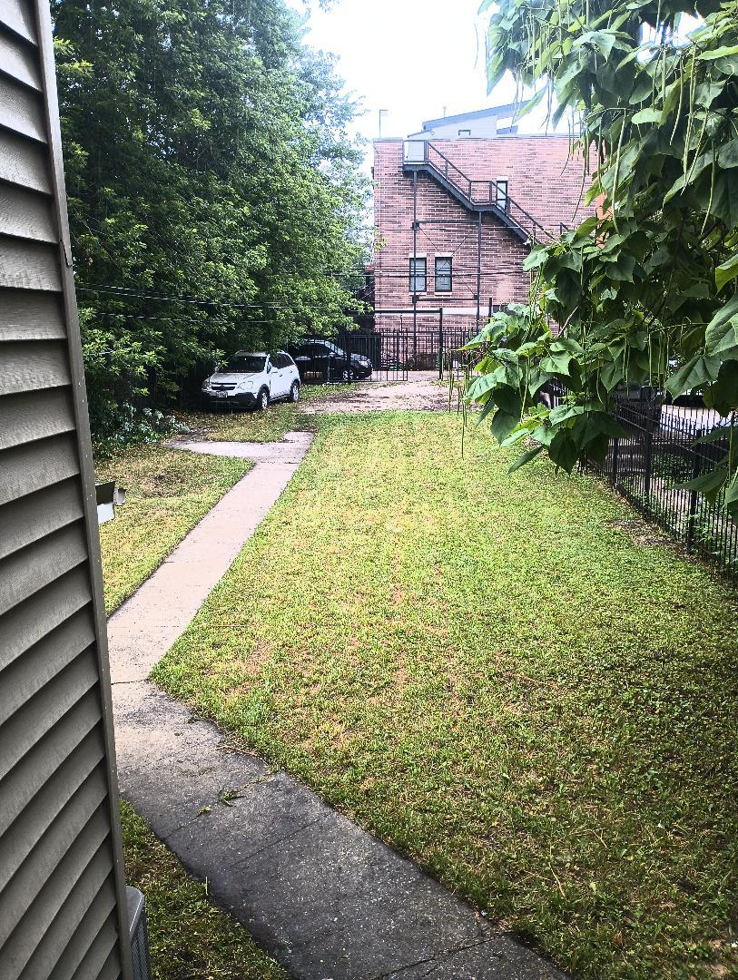 2236 West Monroe Street Chicago, IL 60612 - Photo 34 of 36 a view of a backyard with table and chairs and potted plants