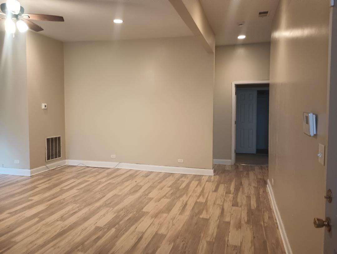 2236 West Monroe Street Chicago, IL 60612 - Photo 7 of 36 a view of an empty room with wooden floor