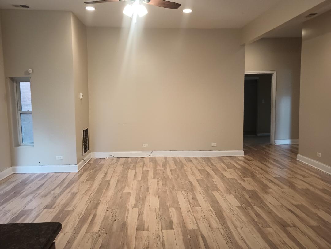 2236 West Monroe Street Chicago, IL 60612 - Photo 8 of 36 a view of an empty room and wooden floor