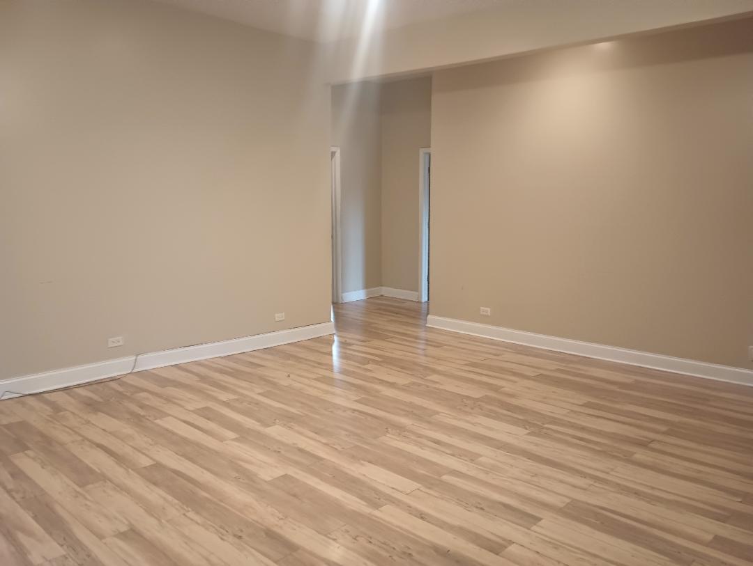 2236 West Monroe Street Chicago, IL 60612 - Photo 9 of 36 a view of an empty room with wooden floor
