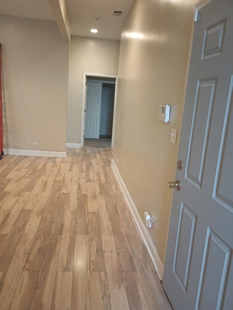 2236 West Monroe Street Chicago, IL 60612 - Photo 10 of 36 a view of an empty room with wooden floor and a bathroom