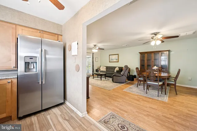 a living room with furniture wooden floor and a view of kitchen
