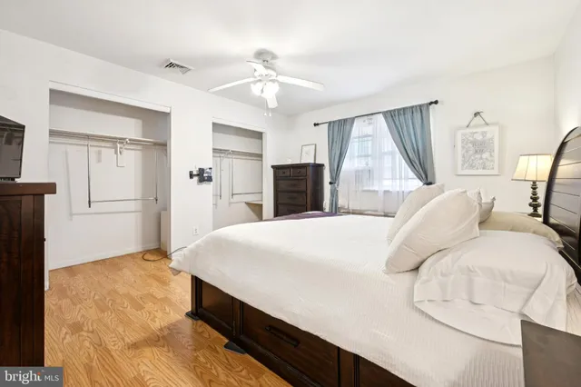 a bed sitting in a bedroom and wooden floor