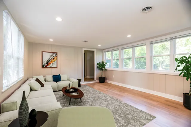 a living room with furniture and a large window