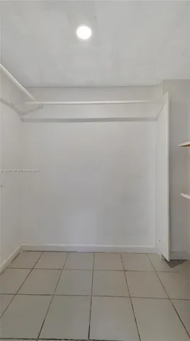 a bedroom with a bed and cabinets