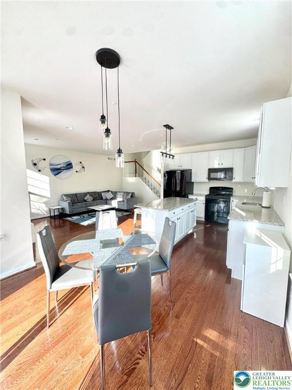 370 Redclover Lane Allentown, PA 18104 - Photo 11 of 33 a living room with stainless steel appliances kitchen island granite countertop a sink a stove and white cabinets with wooden floor