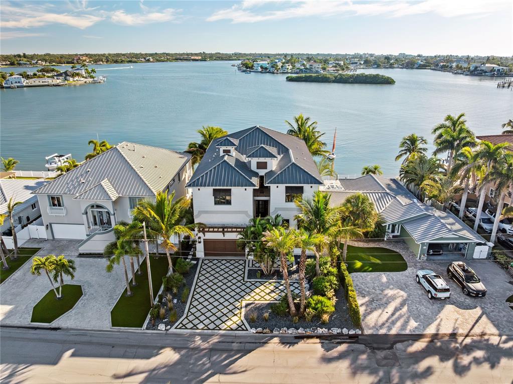459 20th Avenue Indian Rocks Beach, FL 33785 - Photo 2 of 70 a front view of a house with lake view and a floor to ceiling window
