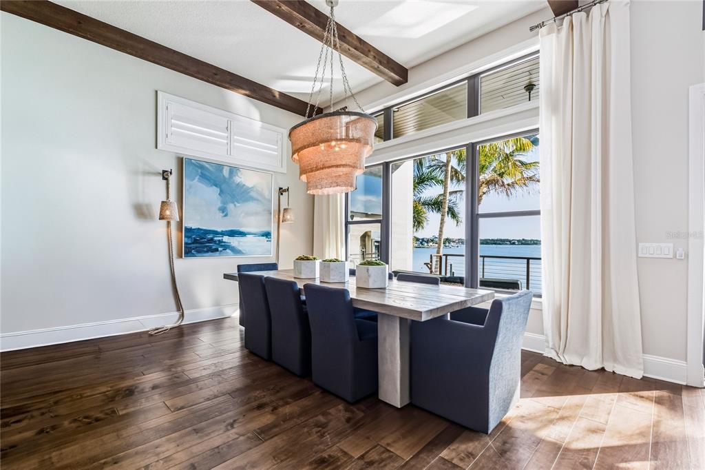 459 20th Avenue Indian Rocks Beach, FL 33785 - Photo 22 of 70 a view of a dining room with furniture large windows and wooden floor