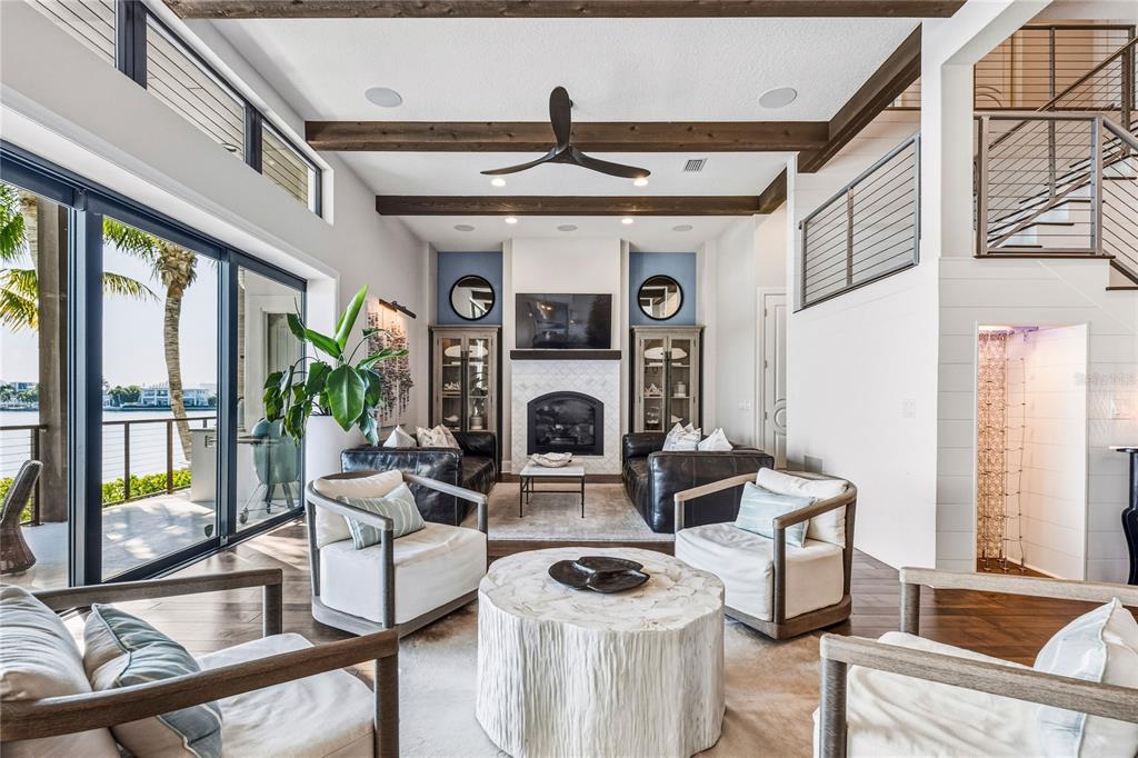 459 20th Avenue Indian Rocks Beach, FL 33785 - Photo 24 of 70 a living room with furniture a fireplace and a floor to ceiling window
