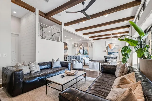 a large bedroom with furniture large windows and a flat screen tv