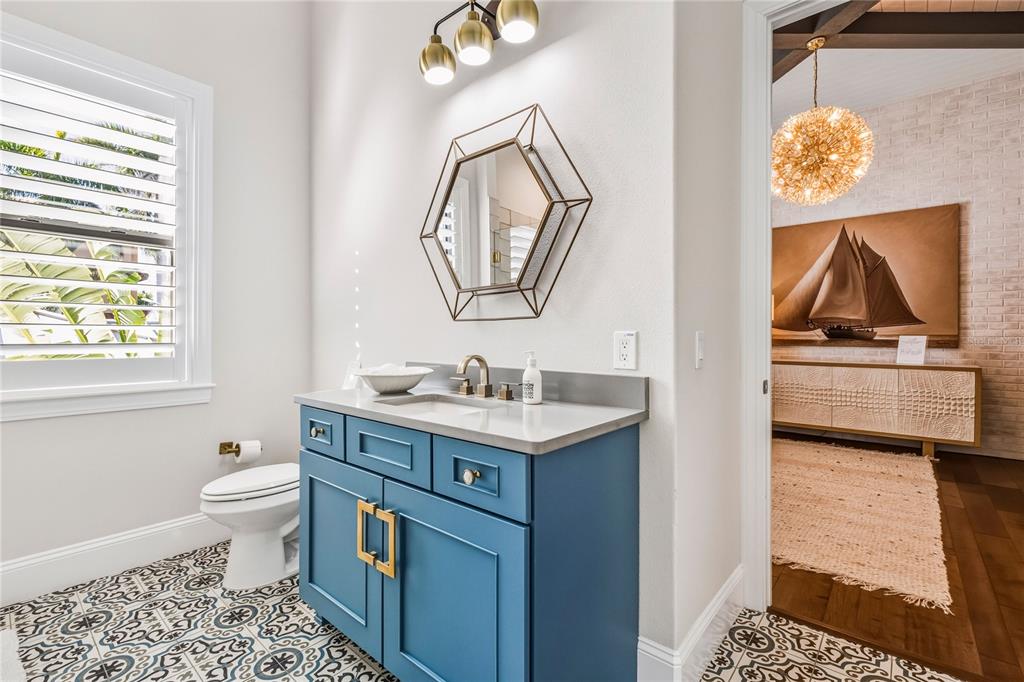 459 20th Avenue Indian Rocks Beach, FL 33785 - Photo 30 of 70 a bathroom with a sink a toilet and a mirror