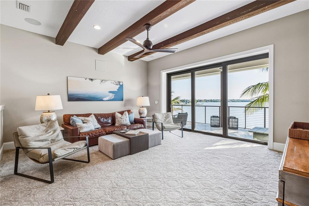 459 20th Avenue Indian Rocks Beach, FL 33785 - Photo 36 of 70 a large bedroom with furniture large windows and a flat screen tv