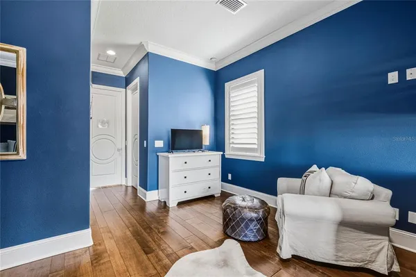 a bed sitting in a bedroom next to a window