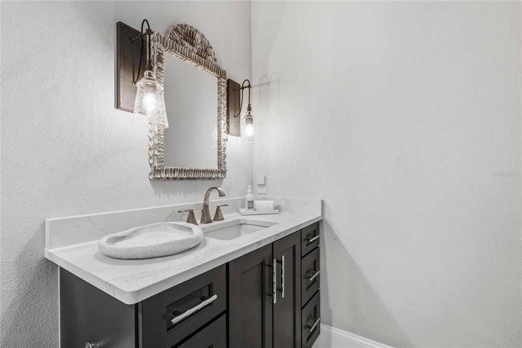 459 20th Avenue Indian Rocks Beach, FL 33785 - Photo 44 of 70 a bathroom with a sink and a mirror