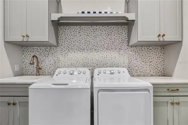 a living room with furniture a large window and wooden floor