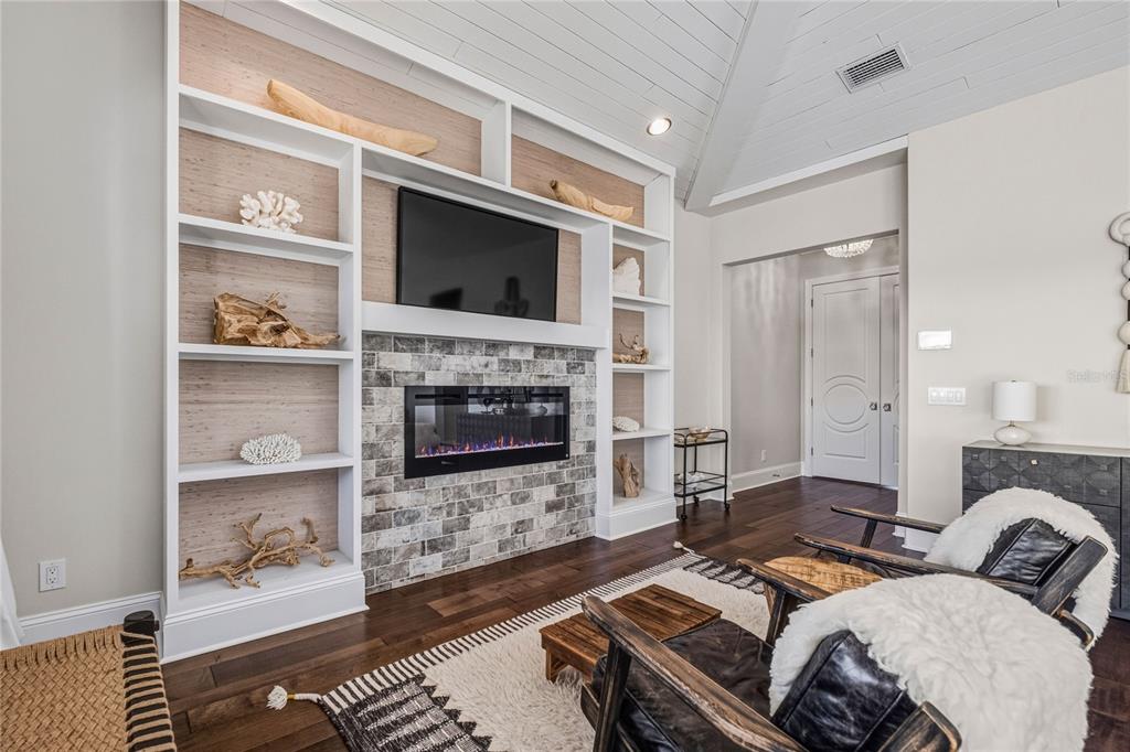 459 20th Avenue Indian Rocks Beach, FL 33785 - Photo 57 of 70 a bedroom with furniture a flat screen tv and a fireplace