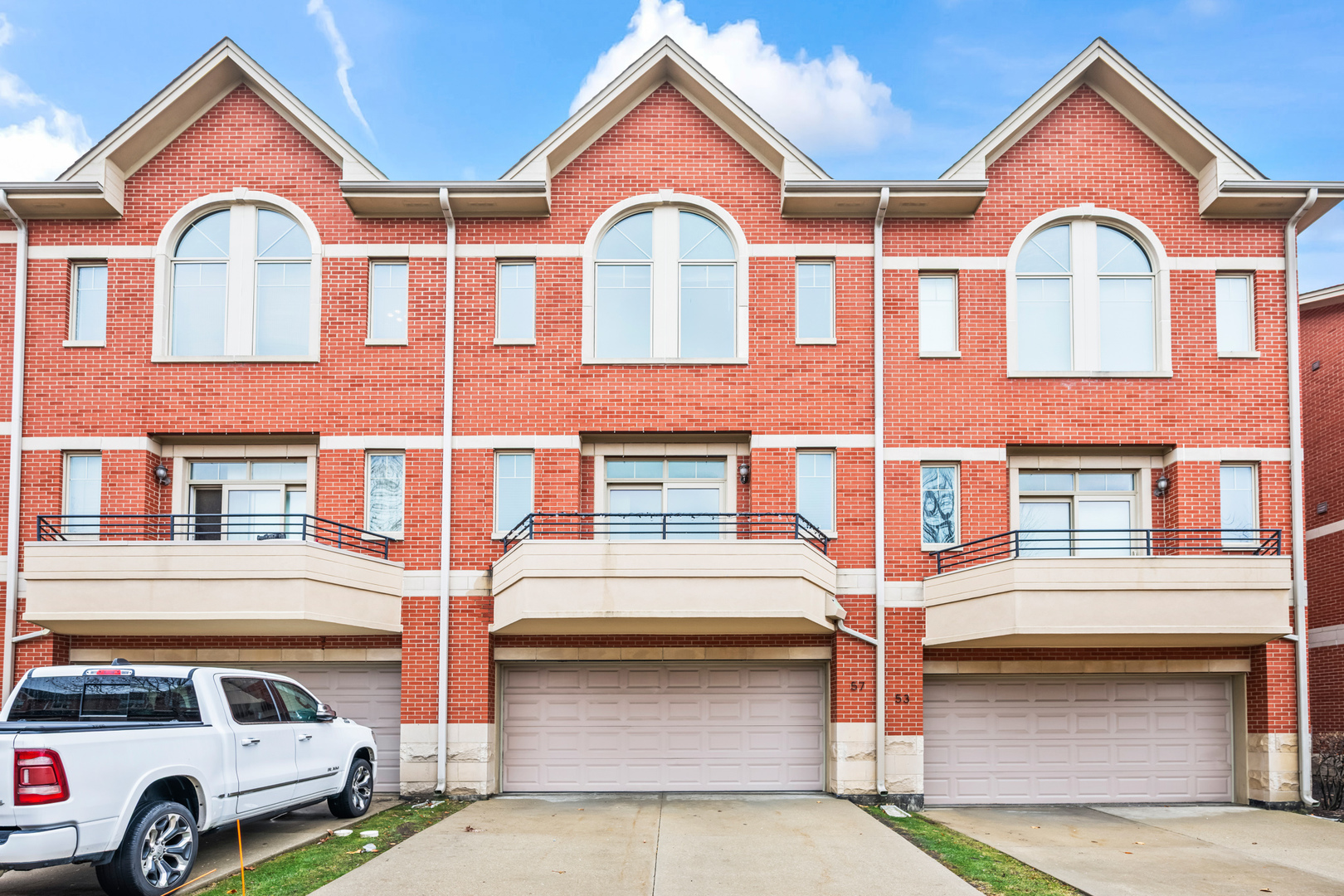 57 Northfield Terrace, Unit 57 Wheeling, IL 60090 - Photo 16 of 16 a front view of a house with parking space