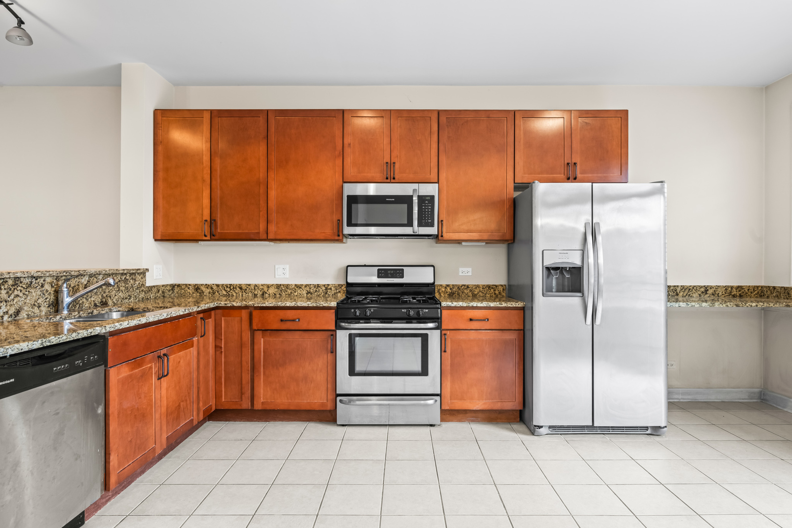 57 Northfield Terrace, Unit 57 Wheeling, IL 60090 - Photo 4 of 16 a kitchen with stainless steel appliances granite countertop a refrigerator sink and stove