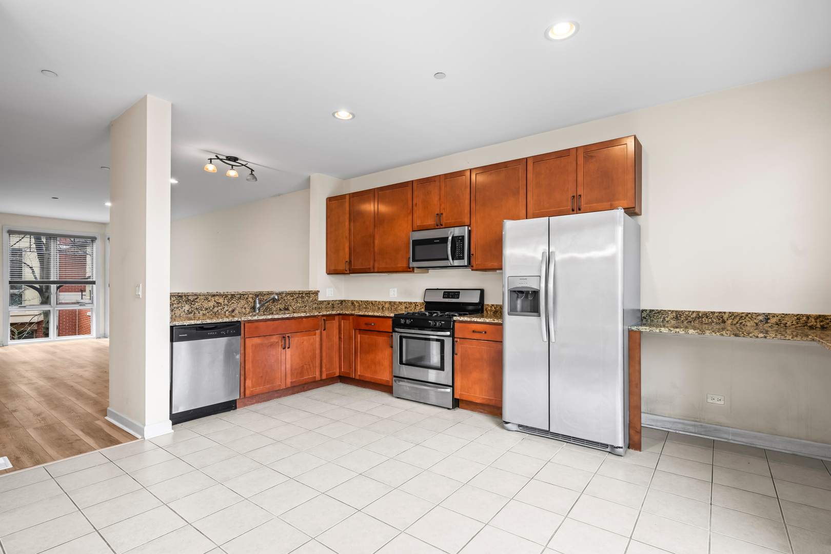 57 Northfield Terrace, Unit 57 Wheeling, IL 60090 - Photo 5 of 16 a kitchen with stainless steel appliances granite countertop a refrigerator and a stove top oven