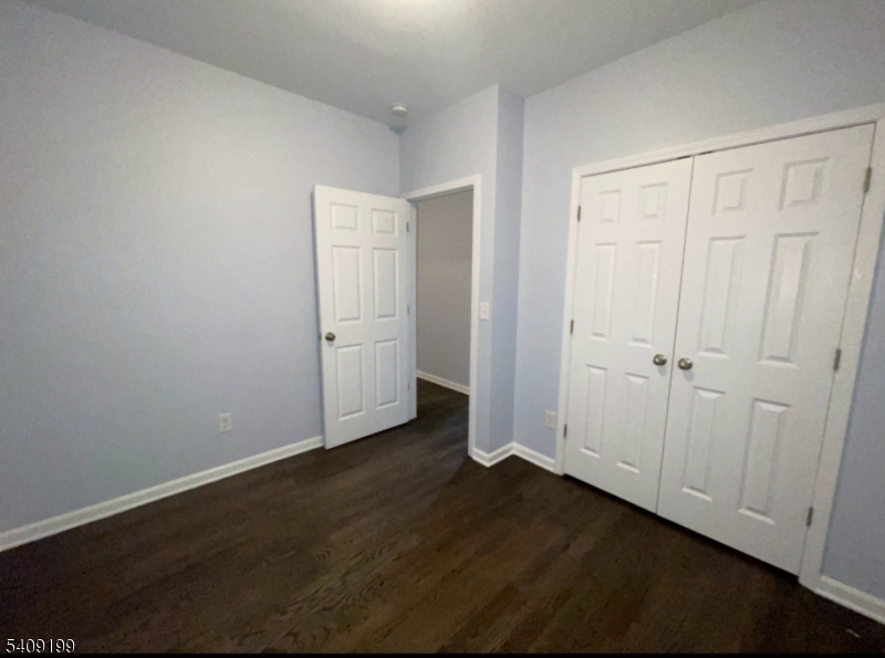 1519 Bower Street Linden, NJ 07036 - Photo 3 of 10 an empty room with wooden floor