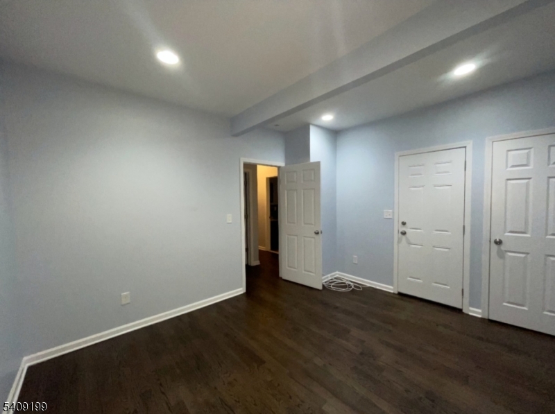 1519 Bower Street Linden, NJ 07036 - Photo 6 of 10 an empty room with wooden floor and closet