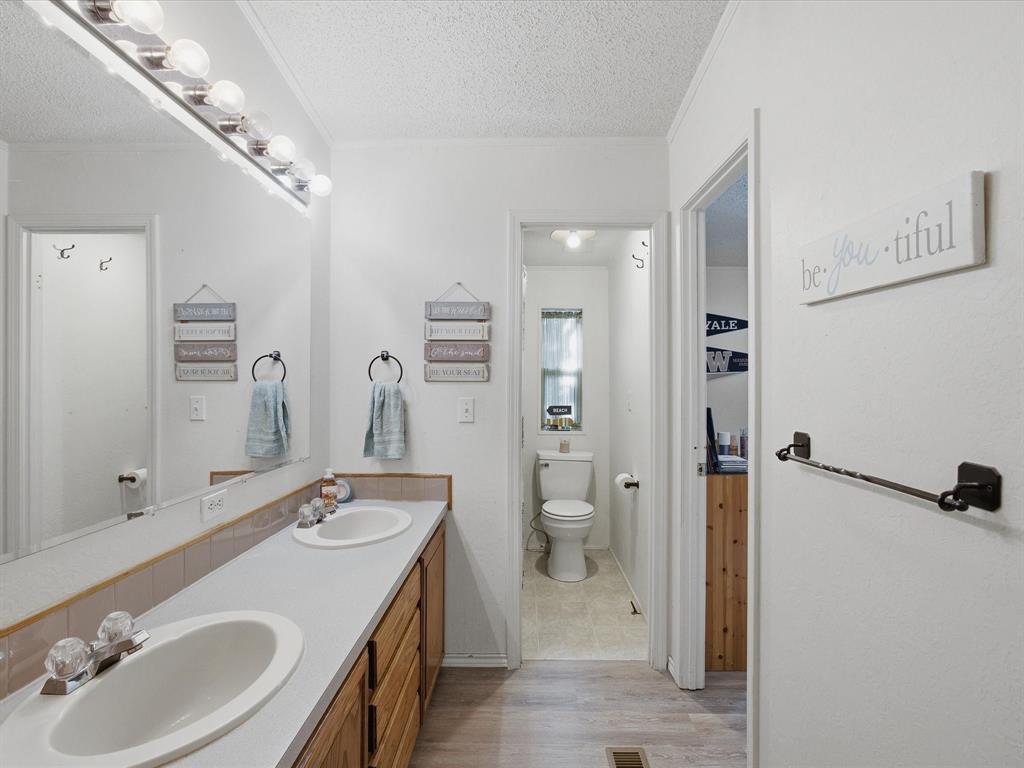 3275 Finis Road Graham, TX 76450 - Photo 23 of 36 a bathroom with a sink toilet and shower