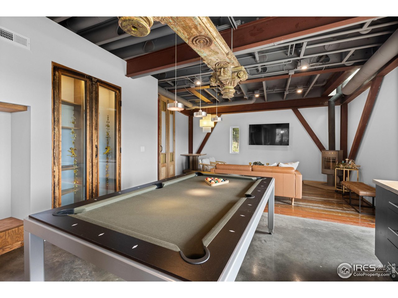 1440 Reed Ranch Road Boulder, CO 80302 - Photo 21 of 40 Pool table that easily converts to dining table in kitchen/dining area. The doors to the cabinet on the left are from a 19th-century bistro in Buenos Aires.