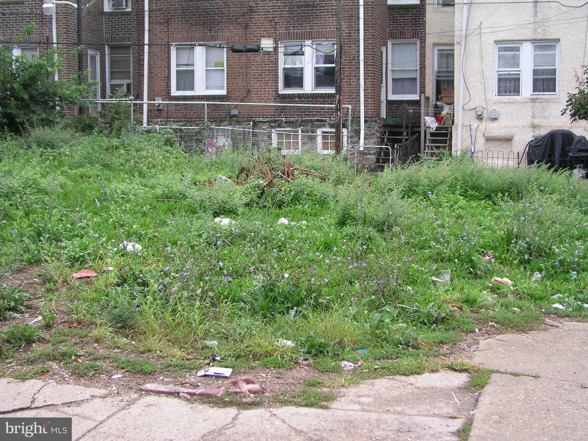 5201 Hawthorne Street Philadelphia, PA 19124 - Photo 2 of 8 a view of a brick house with a yard and plants