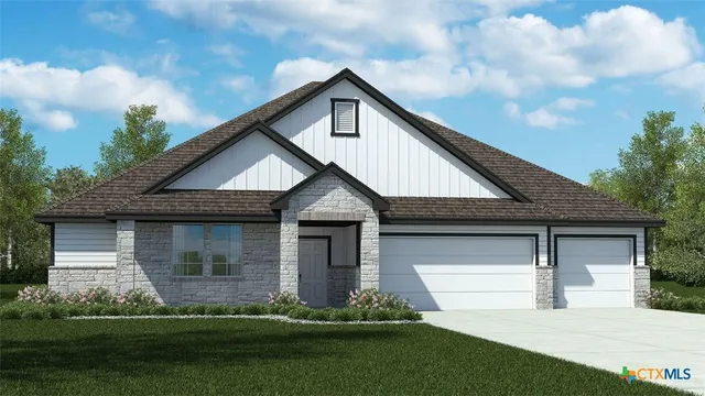 a front view of a house with a yard and trees