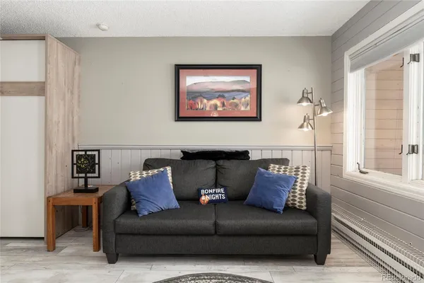 a living room with furniture a couch and a window