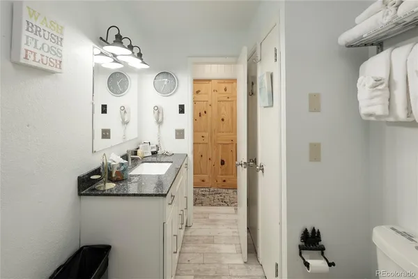 a bathroom with a sink vanity granite and a mirror