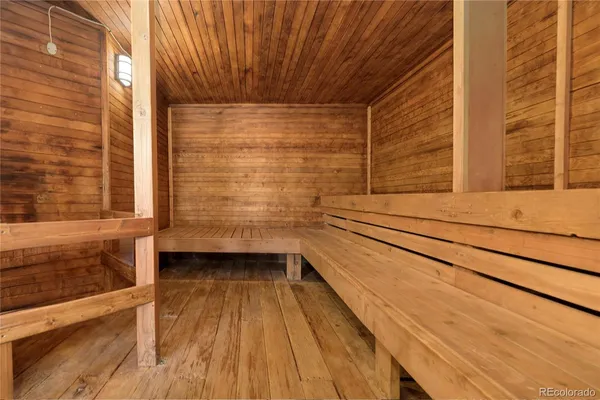 a reading room with wooden floor and furniture