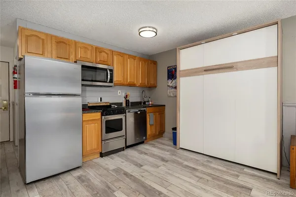 a kitchen with stainless steel appliances a refrigerator sink and microwave