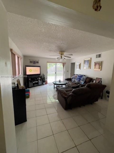 261 East 37th Street Hialeah, FL 33013 - Photo 13 of 13 a living room with furniture and a flat screen tv