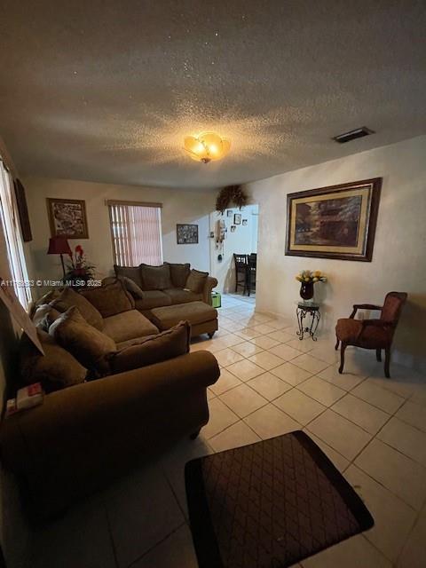261 East 37th Street Hialeah, FL 33013 - Photo 3 of 13 a living room with furniture and a flat screen tv