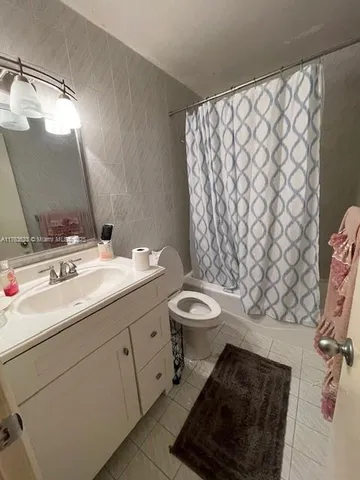 a bathroom with a sink toilet and mirror