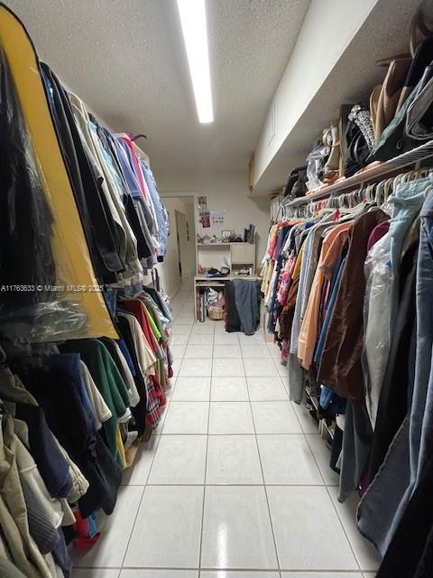 261 East 37th Street Hialeah, FL 33013 - Photo 9 of 13 a view of walk in closet with clothes and shoes