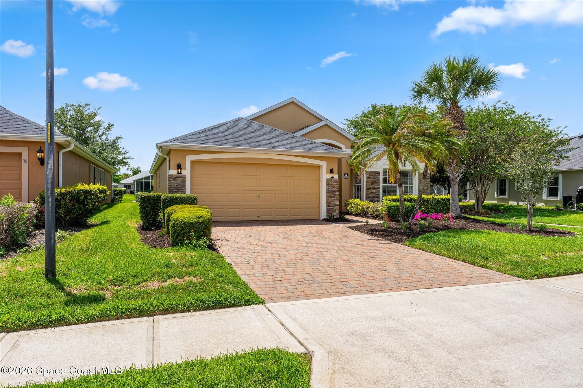 6904 Renshaw Drive Melbourne, FL 32940 - Photo 31 of 46 a front view of a house with garden